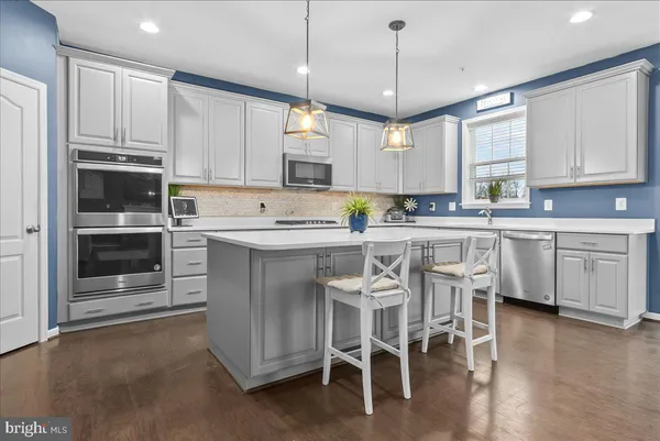 a kitchen with cabinets a sink and appliances
