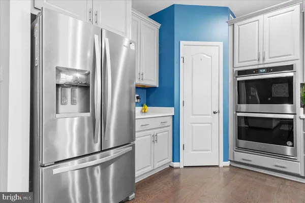 a white refrigerator freezer and a stove sitting inside of a kitchen
