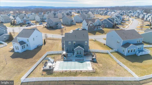 an aerial view of a house with a swimming pool