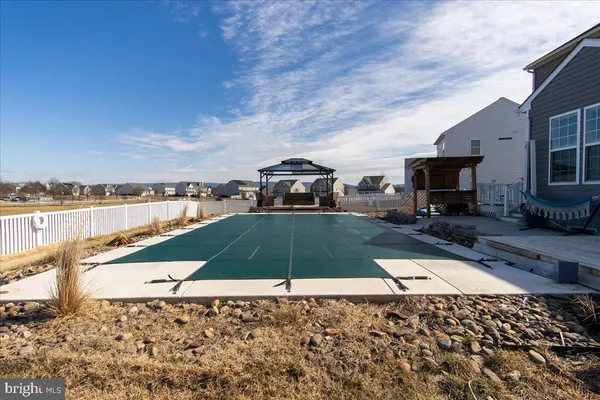 a bathroom with a granite countertop shower and a mirror