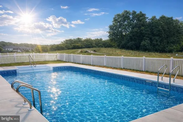 a view of a swimming pool with a patio and a yard