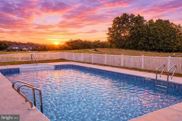 a view of a swimming pool with a lounge chair