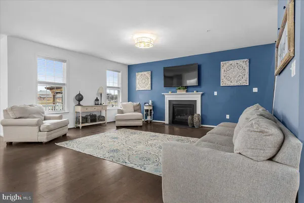 a living room with furniture flat screen tv and a fireplace