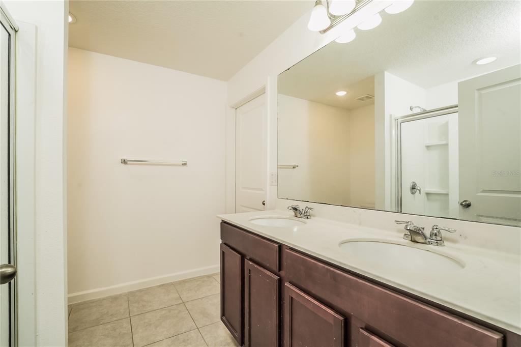 1473 Lucerne Loop Road Northeast Winter Haven, FL 33881 - Photo 20 of 25 a bathroom with a sink and a mirror