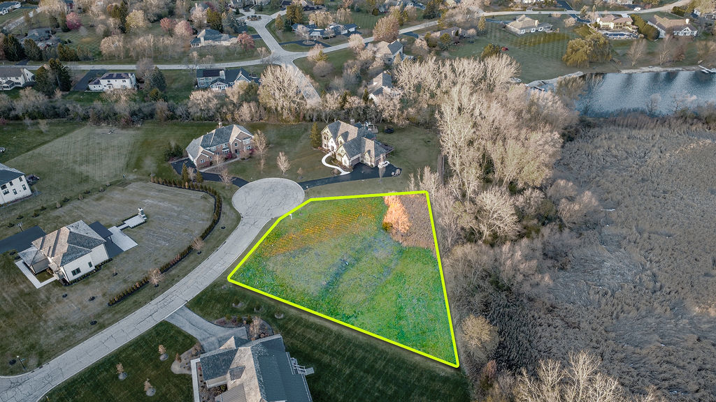 23697 North Matthew Court Long Grove, IL 60047 - Photo 4 of 17 an aerial view of a house with a garden and lake view