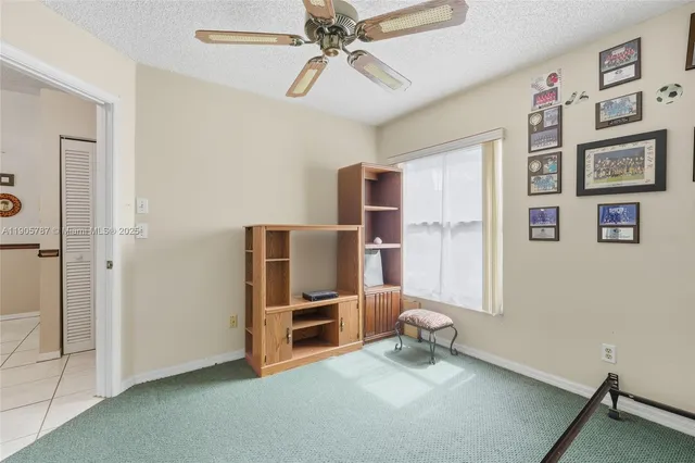 a room with window and a ceiling fan