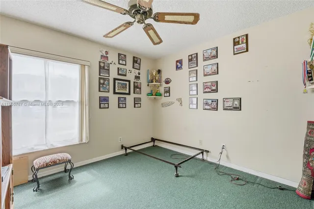 a bathroom with a granite countertop sink a toilet and a mirror