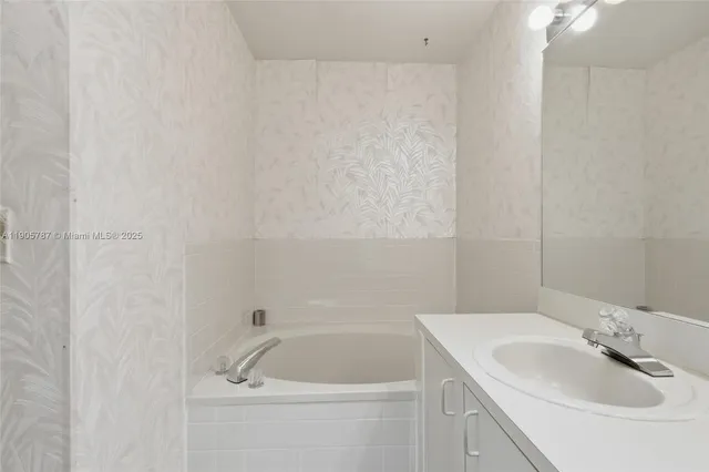 a bathroom with a sink vanity and a mirror