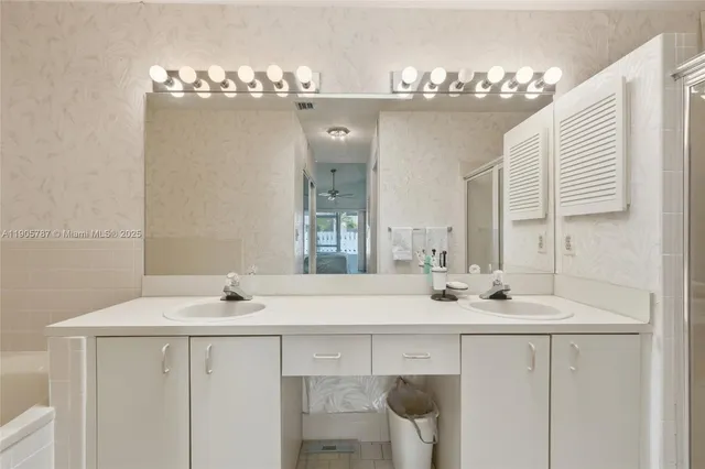 a white toilet sitting next to a white sink
