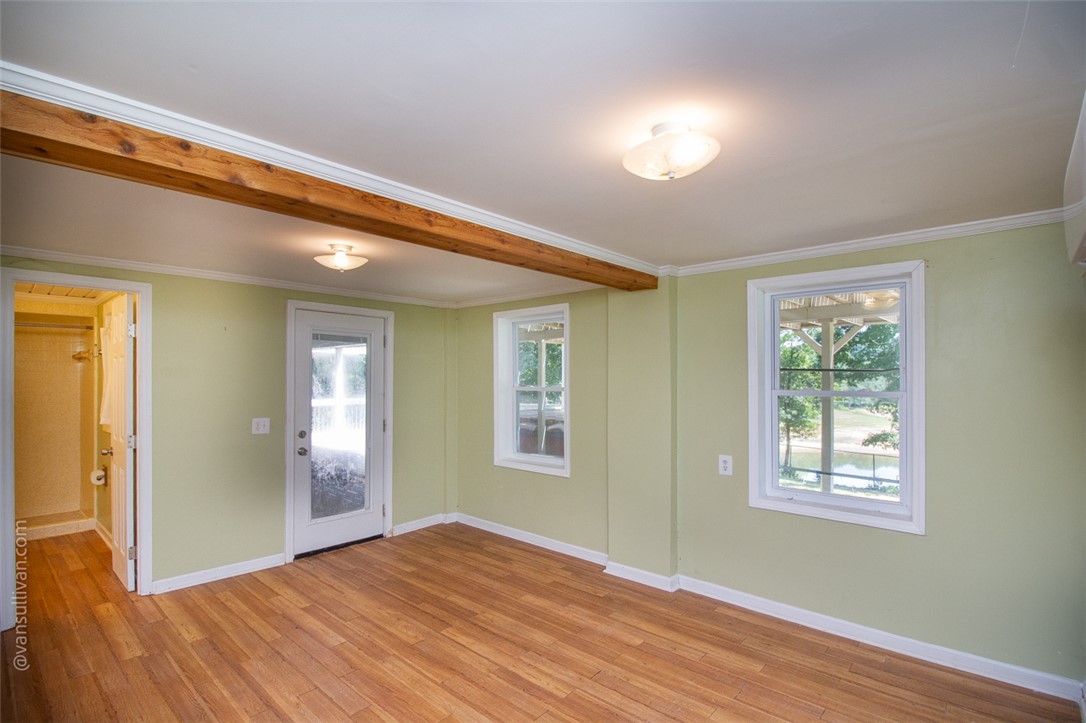 4518 Cove Trail Anderson, SC 29621 - Photo 39 of 49 Rich wood flooring and an exposed timber beam highlight this versatile downstairs iving space, used as the 4th bedroom.