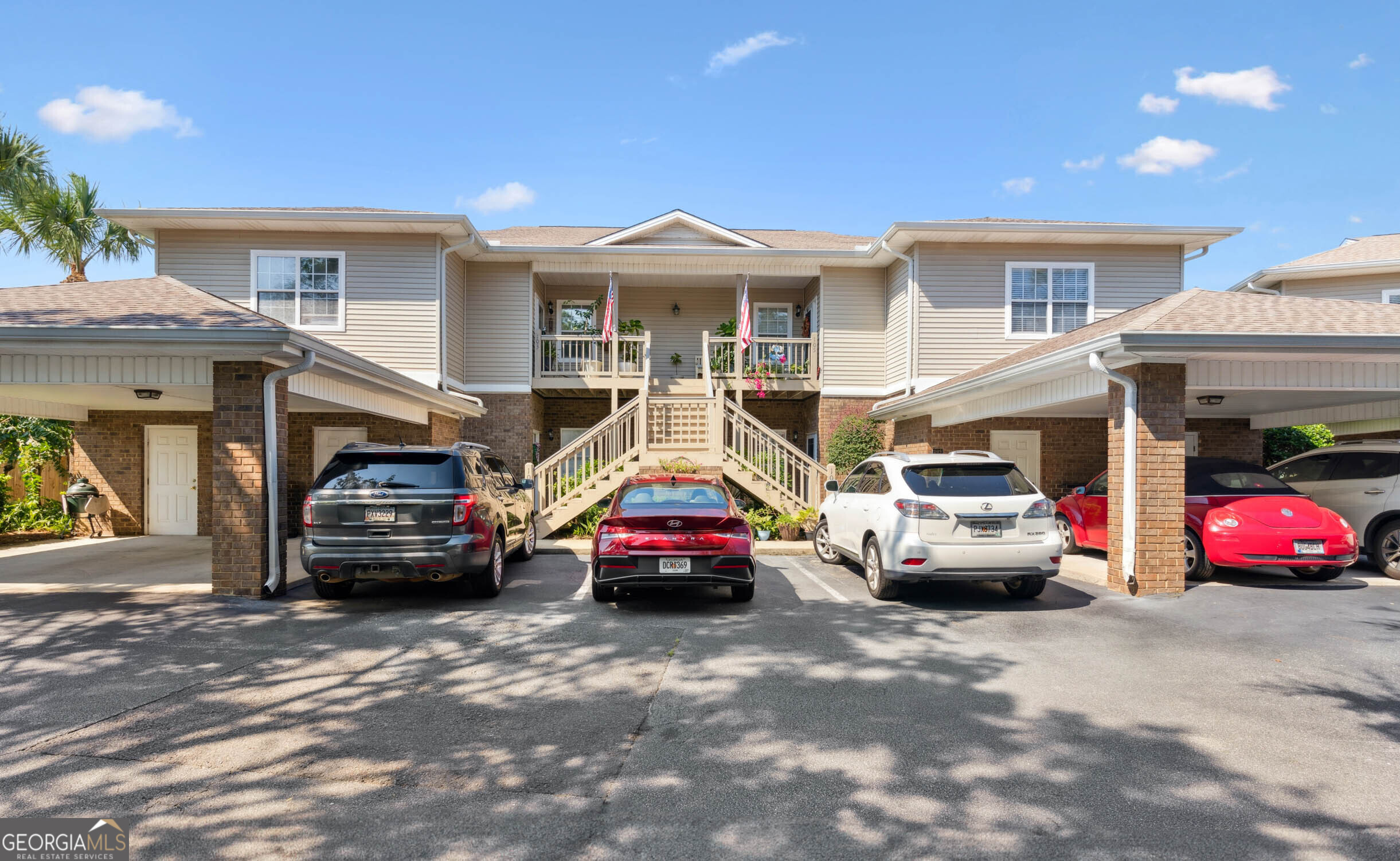 a car parked in front of a white house