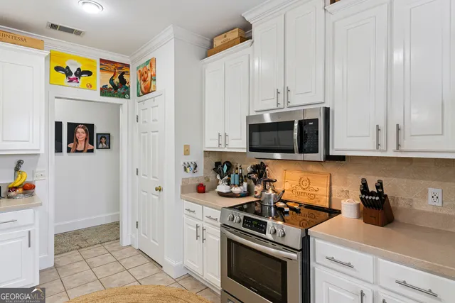 a view of a kitchen with appliances and cabinets