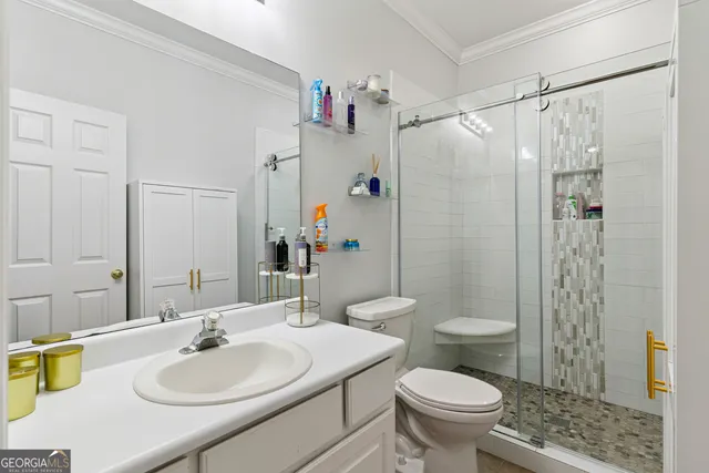 a bathroom with a sink toilet and shower