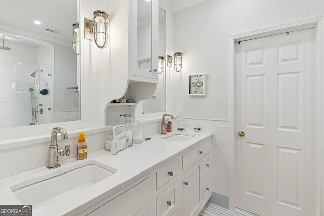a bathroom with double vanity sink a mirror and a bathtub