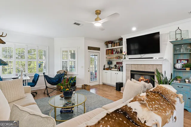 a living room with furniture a fireplace and a flat screen tv