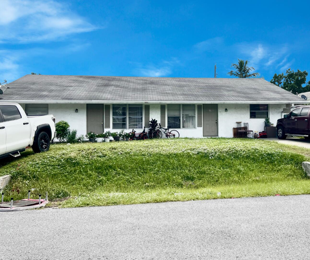 a front view of a house with a garden and plants