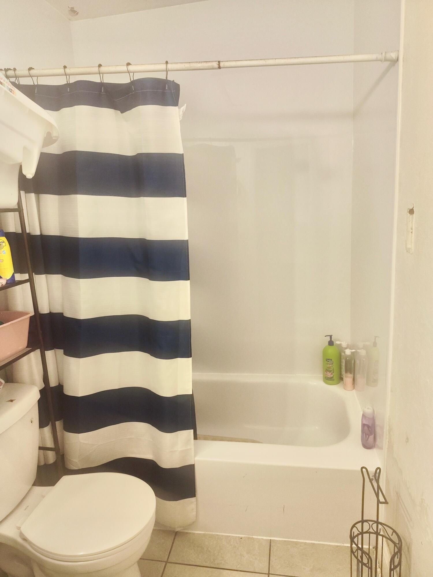 3300 Southeast Fairmont Street Stuart, FL 34997 - Photo 13 of 13 a bathroom with a bathtub and a shower