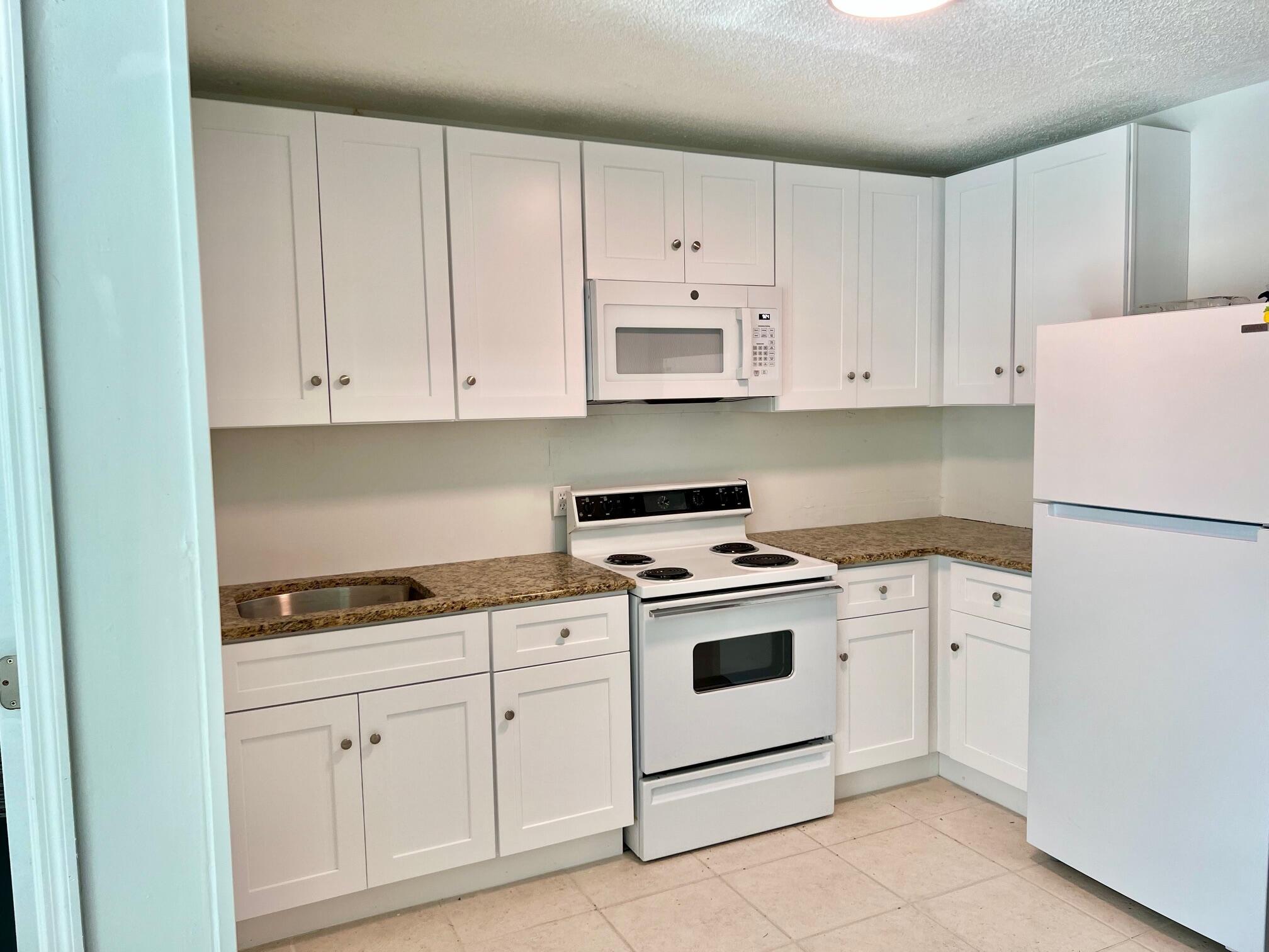 3300 Southeast Fairmont Street Stuart, FL 34997 - Photo 2 of 13 a kitchen with cabinets appliances and a sink
