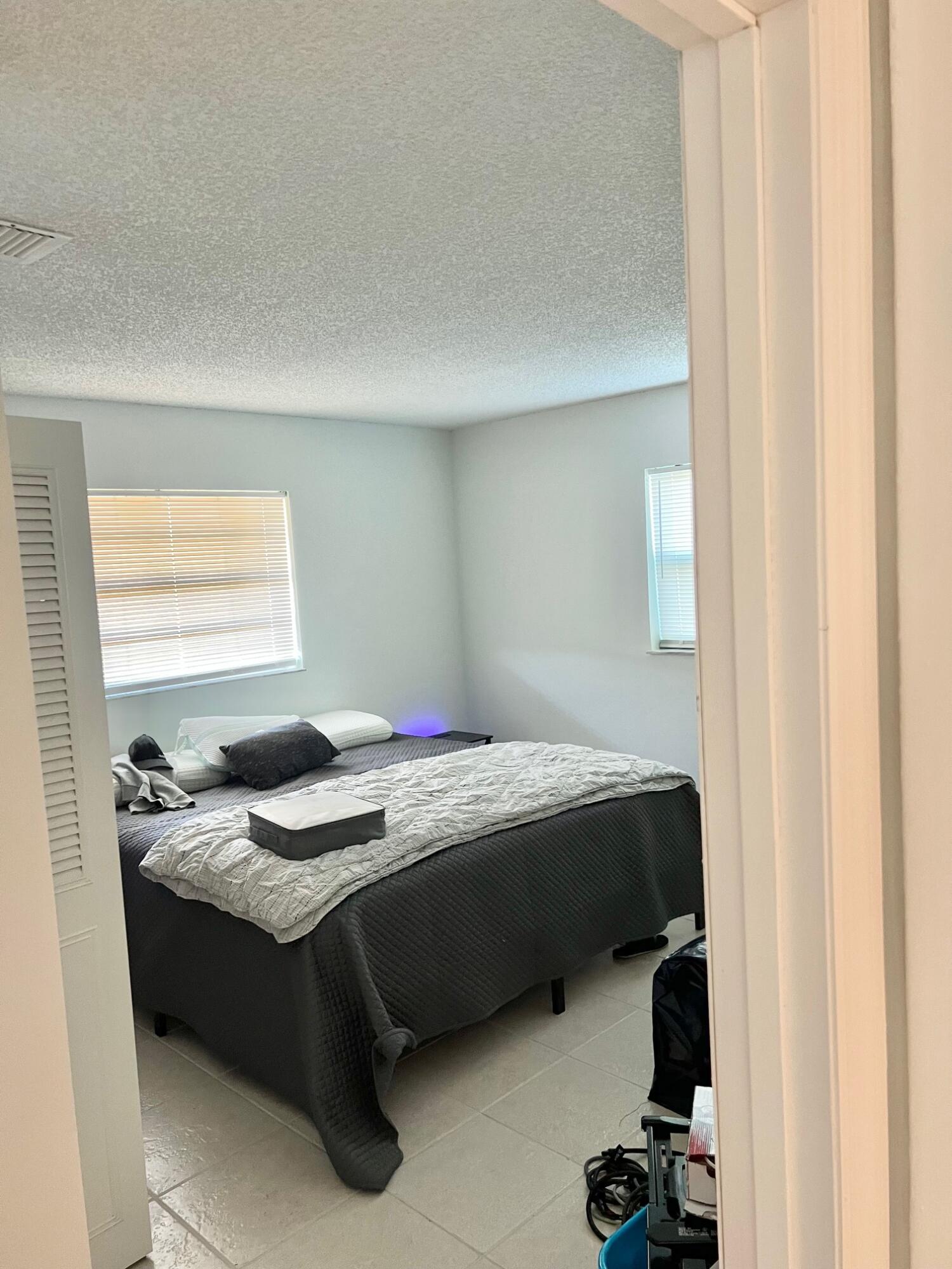 3300 Southeast Fairmont Street Stuart, FL 34997 - Photo 7 of 13 a bedroom with a bed and a window