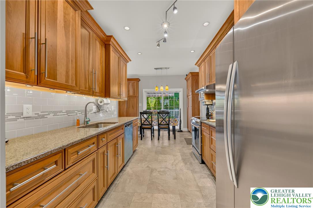 1702 Red Bud Road Quakertown, PA 18951 - Photo 12 of 68 Gleaming wood cabinetry and stainless steel appliances define this well-appointed culinary space.
