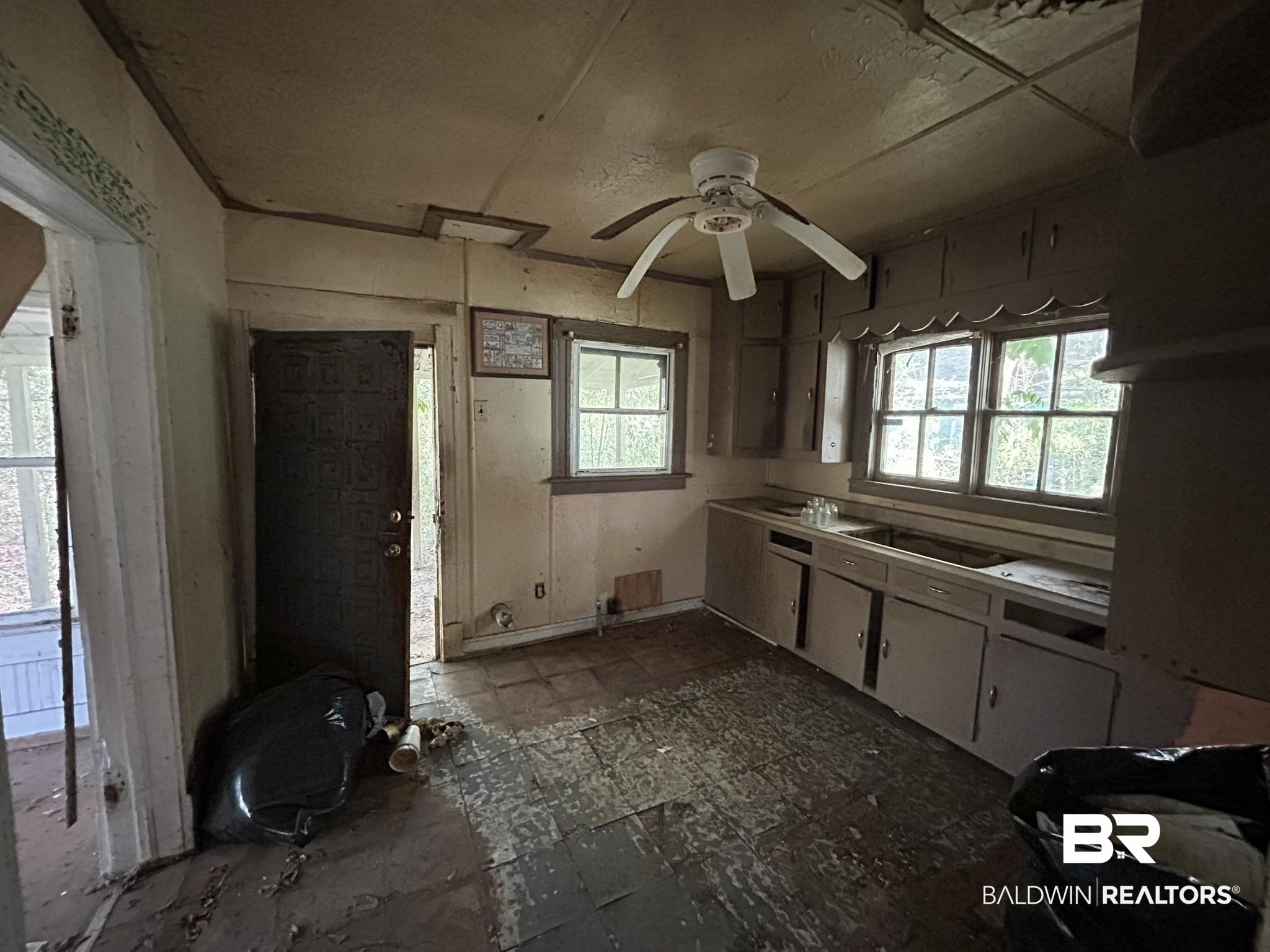 3142 West Turner Road Mobile, AL 36612 - Photo 10 of 19 Kitchen with black electric stovetop, white cabinets, and ceiling fan