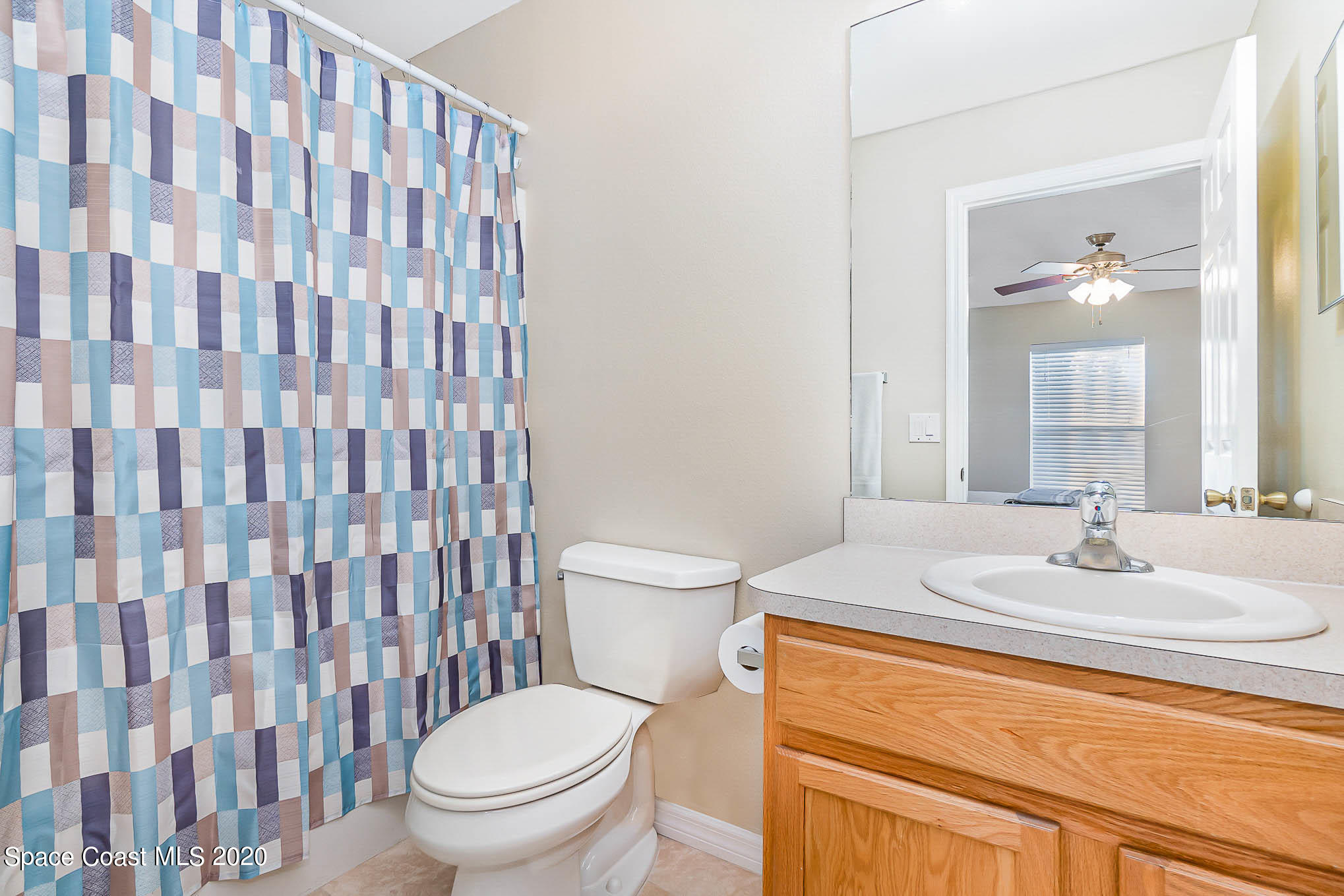 5209 Carrick Road Cocoa, FL 32927 - Photo 12 of 23 a bathroom with a sink toilet and shower