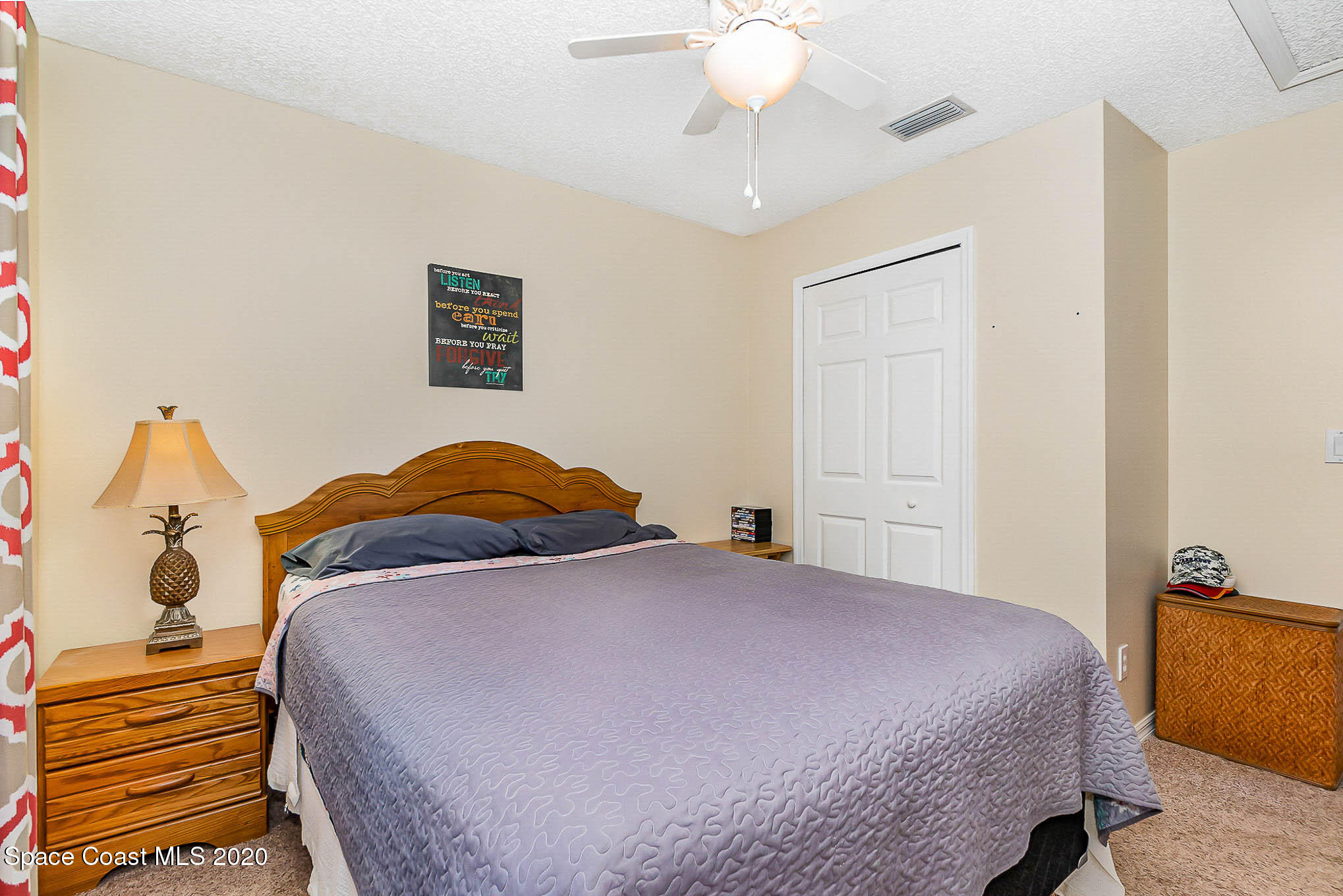 5209 Carrick Road Cocoa, FL 32927 - Photo 13 of 23 a bedroom with a bed and a chandelier