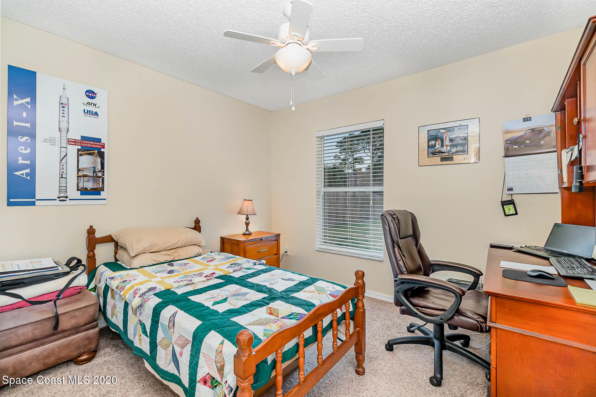 5209 Carrick Road Cocoa, FL 32927 - Photo 16 of 23 a bedroom that has a bed and a desk