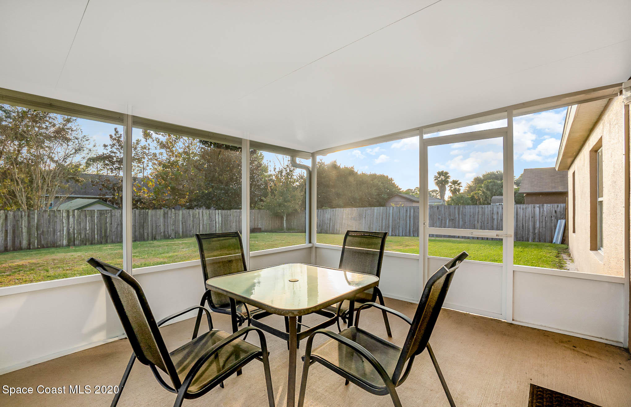 5209 Carrick Road Cocoa, FL 32927 - Photo 17 of 23 a view of a dining room with furniture wooden floor and a floor to ceiling window