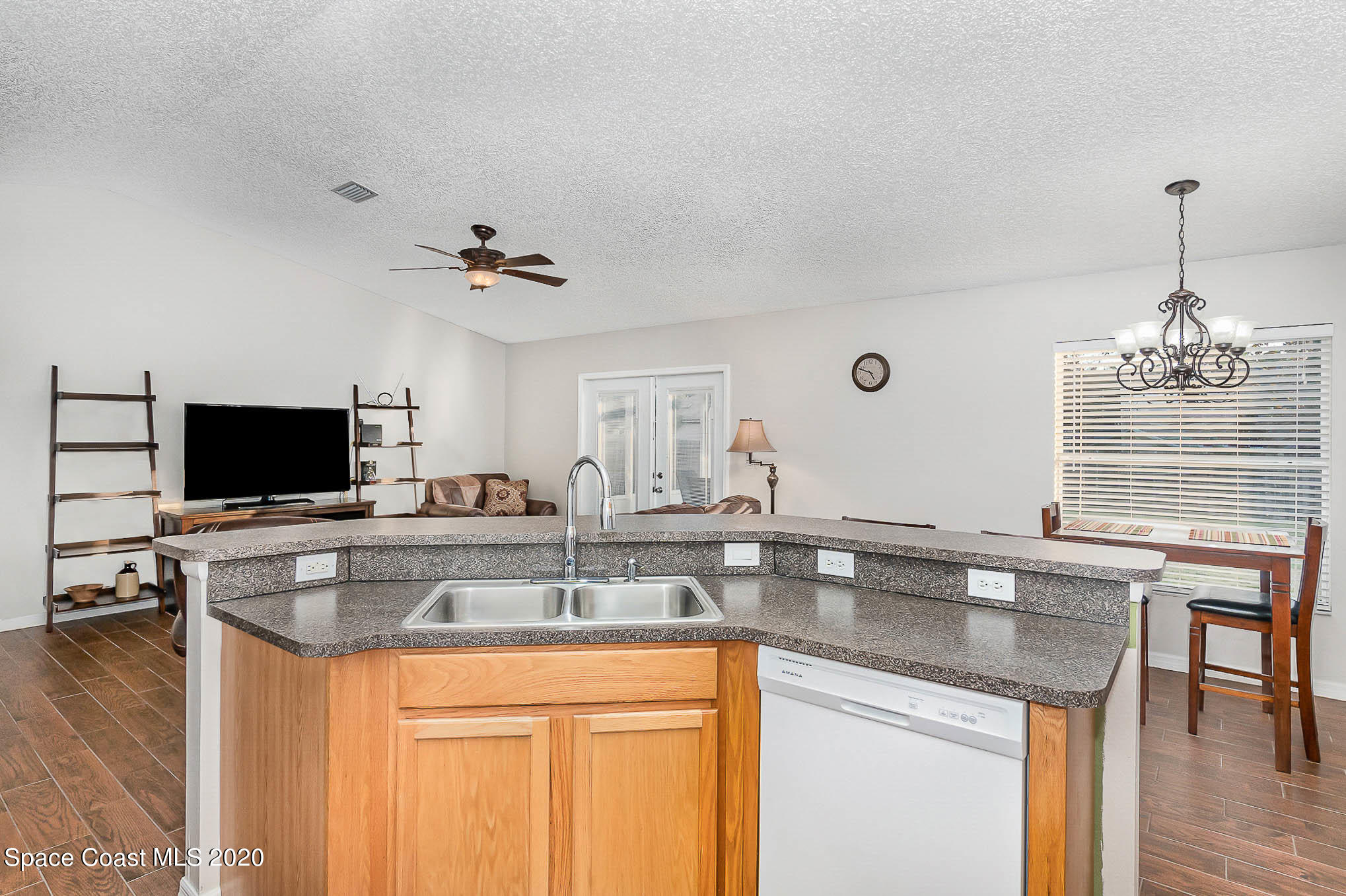 5209 Carrick Road Cocoa, FL 32927 - Photo 8 of 23 a kitchen with a sink and a stove with a living room