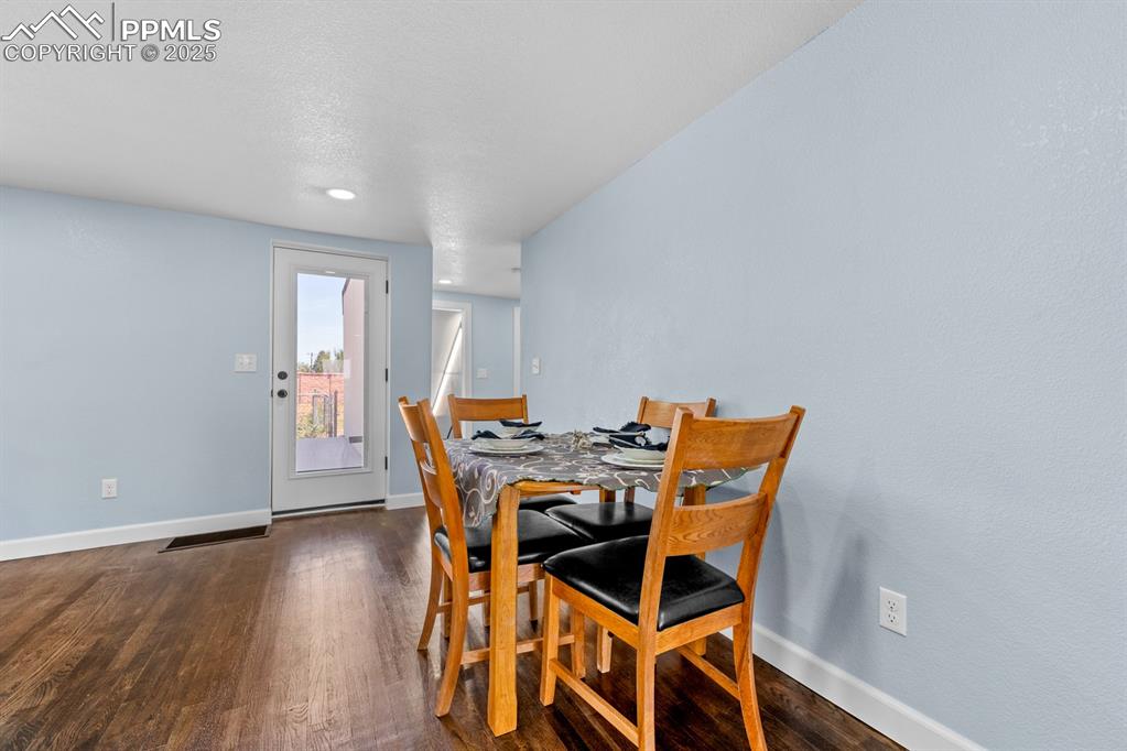 29767 Preston Road Pueblo, CO 81006 - Photo 18 of 46 a view of a dining room with furniture and wooden floor