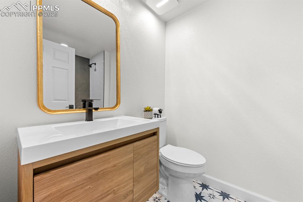 29767 Preston Road Pueblo, CO 81006 - Photo 28 of 46 a bathroom with a sink a toilet and mirror