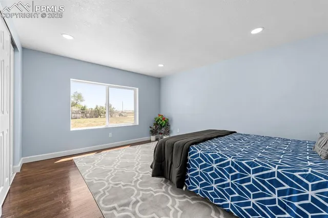 a bedroom with a bed and a lamp