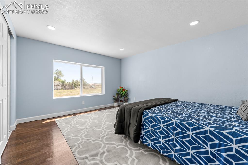 29767 Preston Road Pueblo, CO 81006 - Photo 31 of 46 a bedroom with a large bed and a window