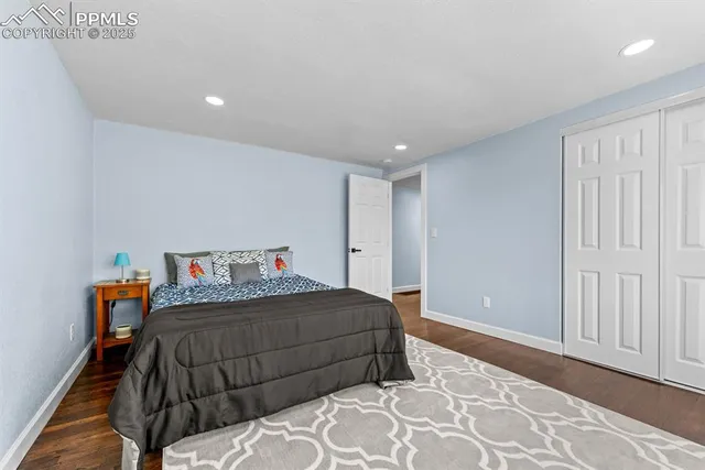 a view of a livingroom with wooden floor and a ceiling fan