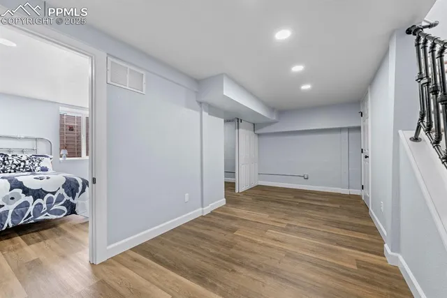 a view of a hallway with wooden floor