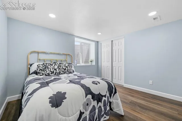 a bed sitting in a bedroom next to a window