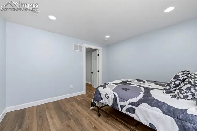 a view of a room with wooden floor and a window