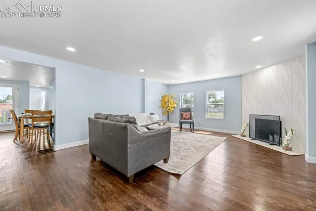 a living room with furniture and a fireplace