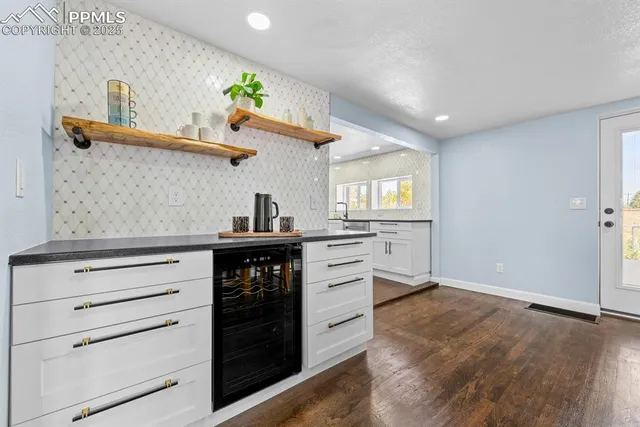 a kitchen with white cabinets and appliances