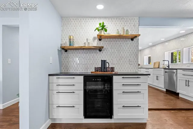 a kitchen with a sink and a stove next to a white cabinet