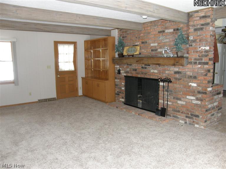 7243 Chillicothe Road Mentor, OH 44060 - Photo 7 of 23 About five feet wide, this terrific fireplace has an antique mantle with wooden pegs. Very rustic. Built in bookshelves are a plus. And the Dutch door can be opened at the middle. Fun!