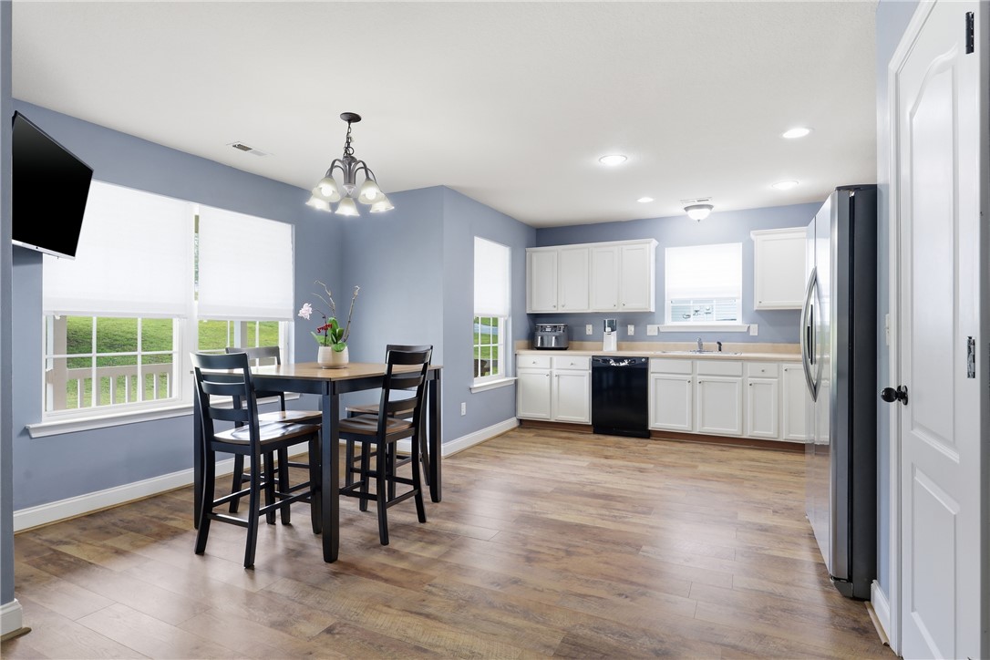105 Lacy Lane Anderson, SC 29621 - Photo 7 of 16 A well-lit kitchen with sleek wooden flooring seamlessly integrates with a cozy dining area.
