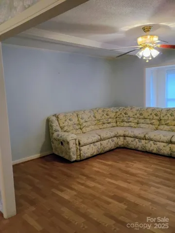 a view of a room with wooden floor and window