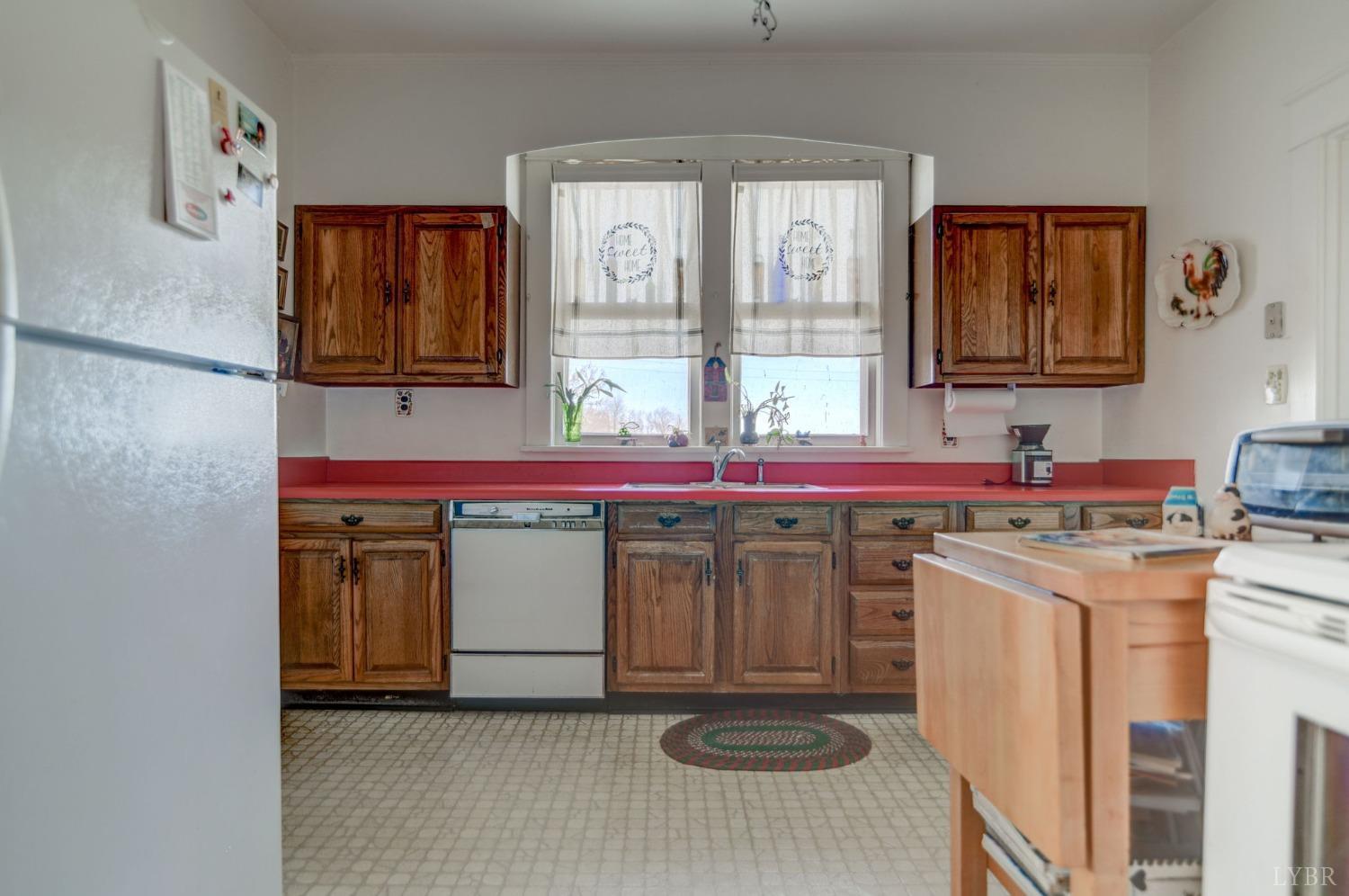 231 Epsons Road Long Island, VA 24569 - Photo 11 of 38 a kitchen with a stove a sink and a refrigerator