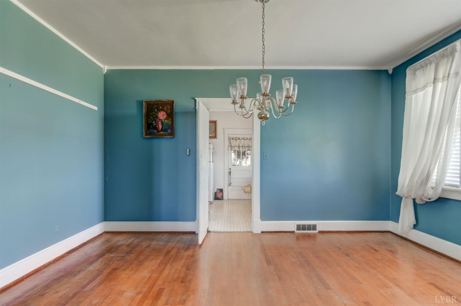 231 Epsons Road Long Island, VA 24569 - Photo 8 of 38 a view of an empty room with wooden floor and a window