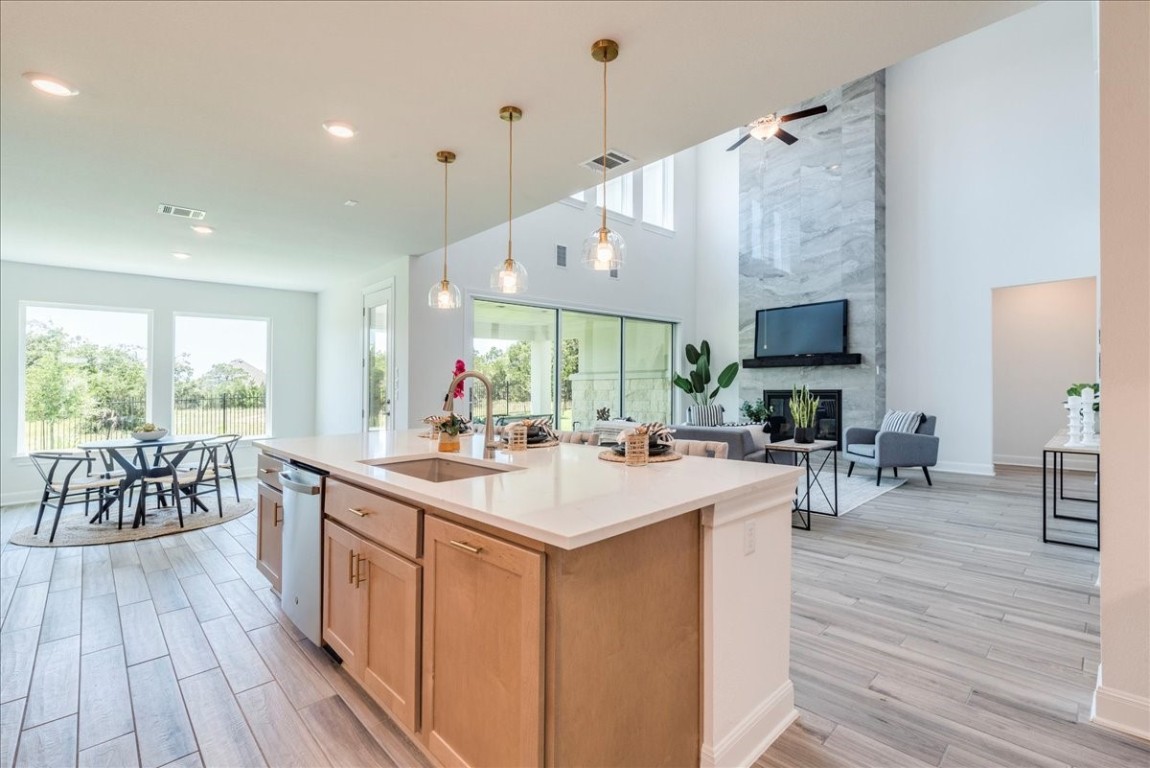 a large kitchen with stainless steel appliances a lot of counter space and a wooden floors