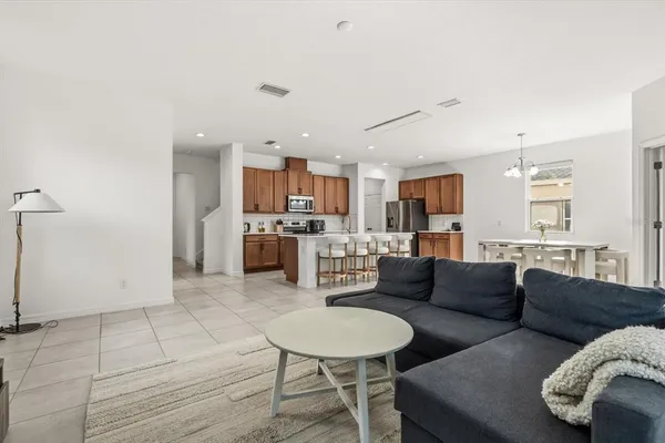 a living room with furniture and kitchen view