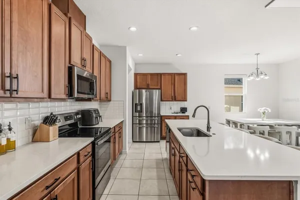 a kitchen with kitchen island a sink appliances and cabinets