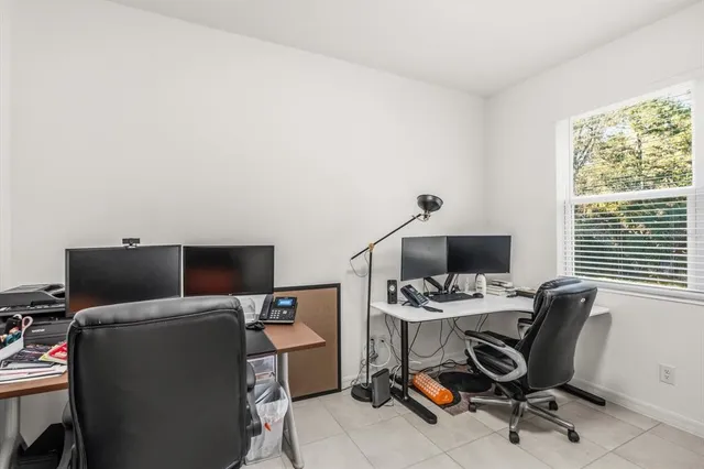 a view of a workspace with furniture and a window